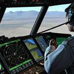 **Electronic Warfare Training Simulation:** A realistic, high-tech virtual training environment showcasing engineers in a simulated electronic warfare scenario, complete with radar displays, communication interfaces, and digital threat visualizations. Focus on the blend of human interaction with advanced technology.